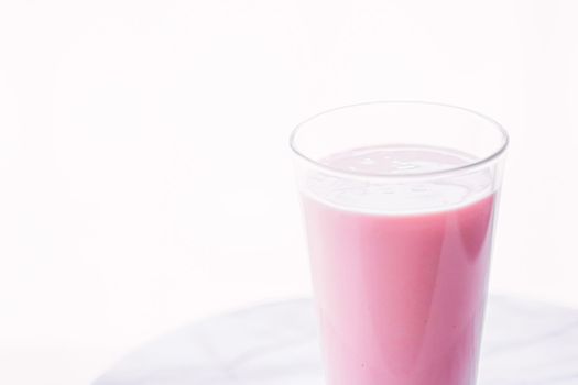 Strawberry milk on marble background as sweet drink, food service and meal delivery concept