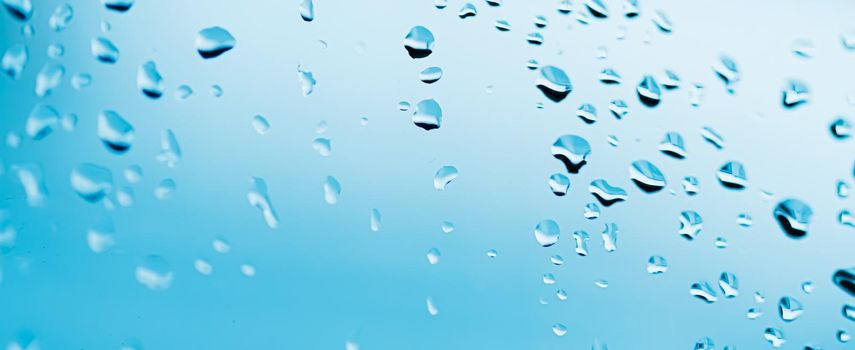 Liquid water drops on glass surface, abstract backdrop and science background concept