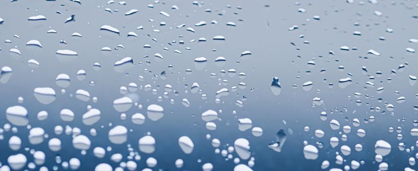 Liquid water drops on glass surface, abstract backdrop and science background concept