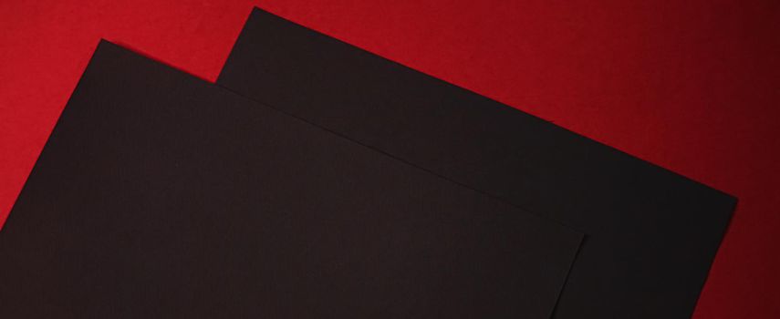 Black A4 papers on red background as office stationery flatlay, luxury branding flat lay and brand identity design for mockups