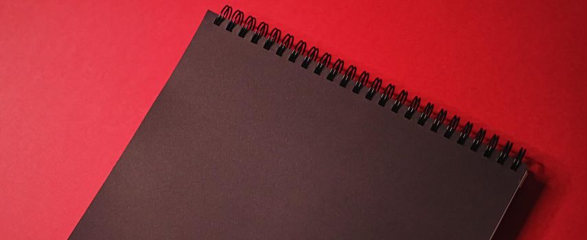 Black notebook on red background as office stationery flatlay, luxury branding flat lay and brand identity design for mockups