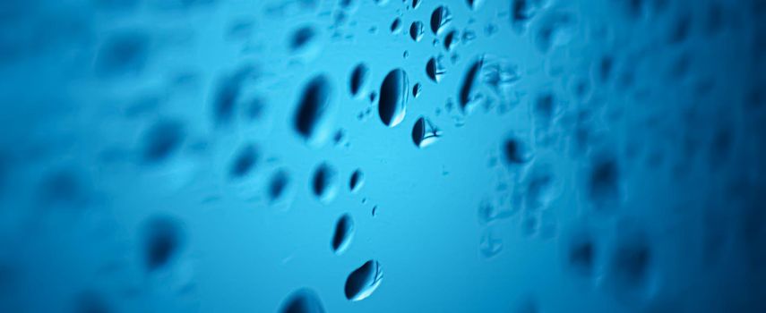 Liquid water drops on glass surface, abstract backdrop and science background concept