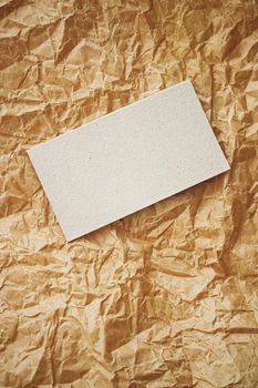 White business card flatlay on brown parchment paper background, luxury branding flat lay and brand identity design for mockups