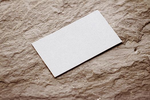 White business card flatlay on brown stone background, luxury branding flat lay and brand identity design for mockups