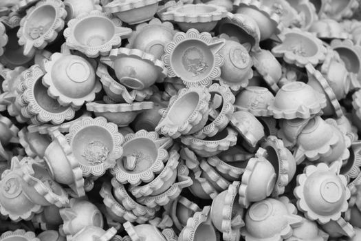 Black and white image of clay lamp (Diya) for sale at Market in india, diya decoration is part of Diwali Festival