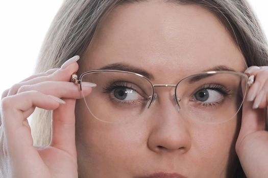 Young beautiful girl trying on new fashionable glasses. Close-up