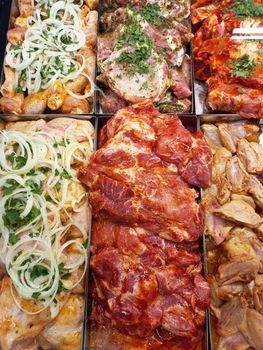 Fresh, marinated meat for barbecue. Appetizing kebabs, raw meat, on the counter in the store. High quality photo