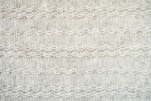 The texture of the woollen product. Grey background. High quality photo