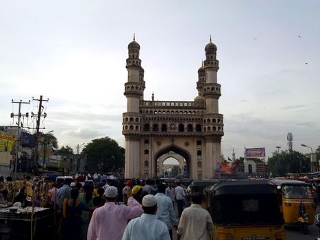 Hyderabad, India - January 2, 2016: Hyderabad, India autorikshow waiting for passengers by the landmark Charminar tower.