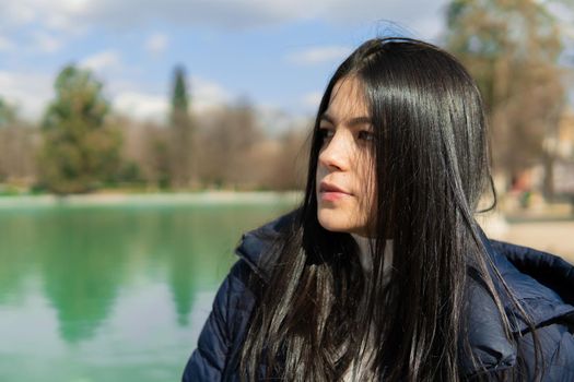 Portrait of young colombian girl with lake in the background