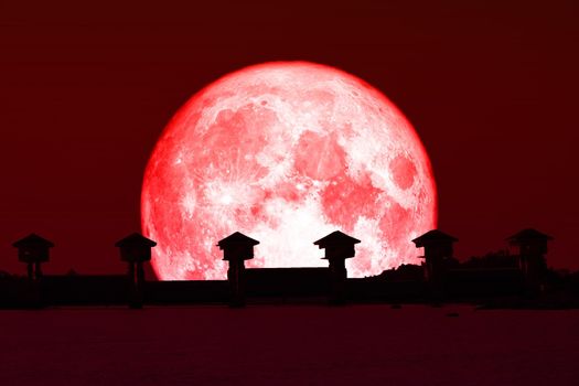 Super red moon and silhouette dam in the dark red sky, Elements of this image furnished by NASA