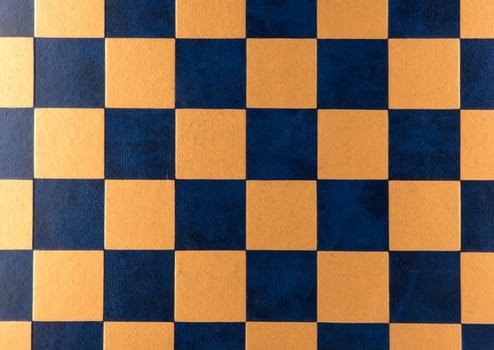 Chess board. Leather checkered texture background of blue and gold color