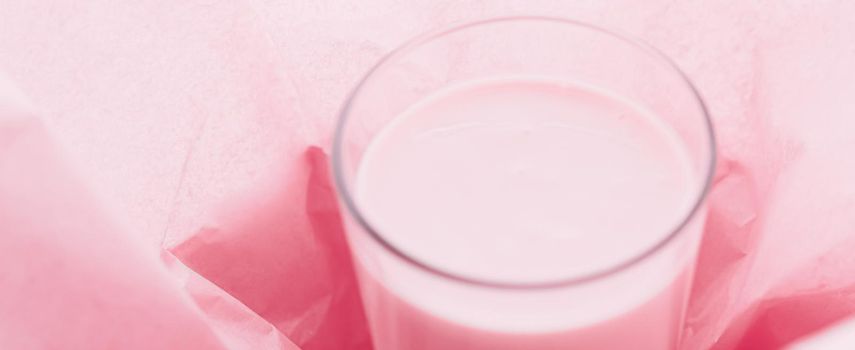 Strawberry milk inside pink paper packaging as sweet drink, food service flat lay and meal delivery concept