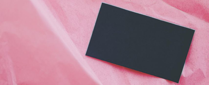 Black business card flatlay on pink tissue paper background, luxury branding flat lay and brand identity design for mockups