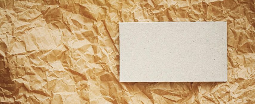 White business card flatlay on brown parchment paper background, luxury branding flat lay and brand identity design for mockups