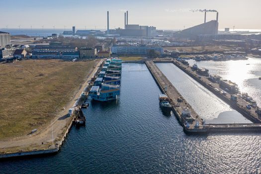 Copenhagen, Denmark - February 25, 2021: Drone view of Urban Rigger, a housing unit floating on water by architect Bjarke Ingels Group