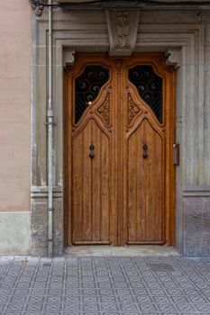 Nice wooden door in one of the streets of Barcelona in Spain.