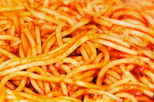 Background with spaghetti with tomato sauce. Italian food. Full frame shot of spaghetti Bolognese. Typical Italian recipe.