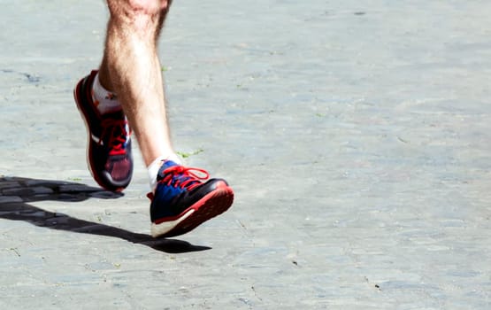 man running a city marathon. Outdoor activity. Sport and wellness.