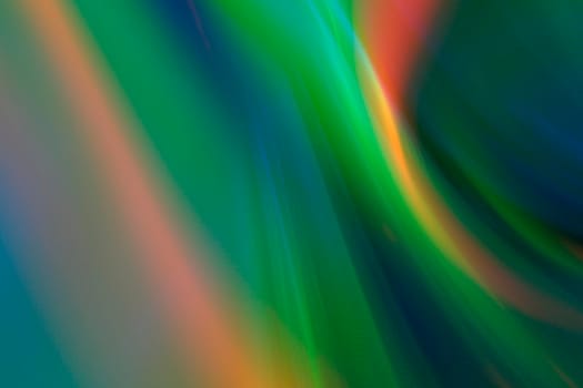 Abstract blurry green background with rainbow glow.