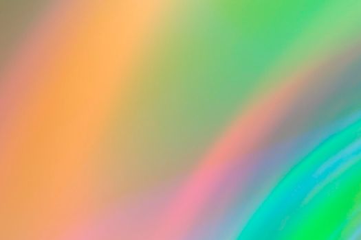 Abstract blurry green background with rainbow glow.