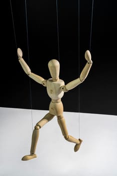 a wooden mannequin controlled with wires