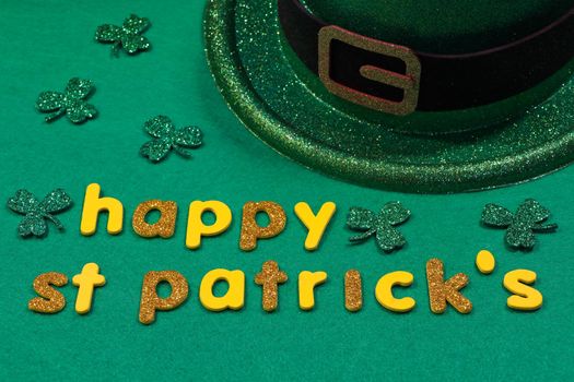 St Patrick's day yellow and gold happy St Patrick's lettering with shamrock clovers and leprechaun hat