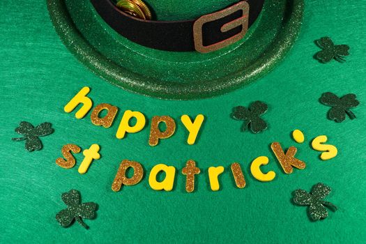 St Patrick's day yellow and gold happy St Patrick's lettering with shamrock clovers and green leprechaun hat with gold coins