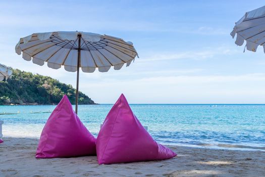 Pink inflatable sofa on the beach.