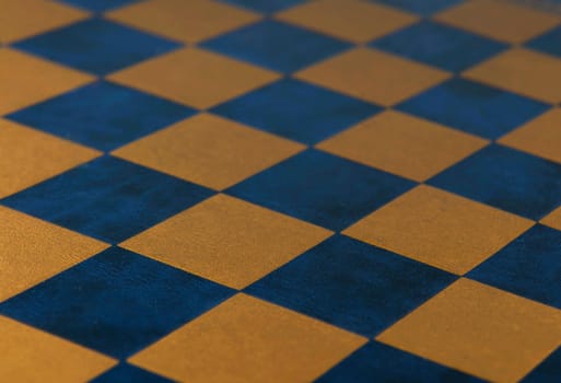 Chess board. Leather checkered texture background of blue and gold color