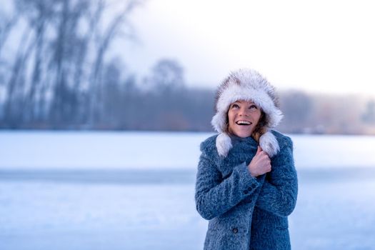 young woman in winter clothes in nature.