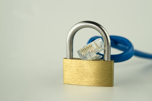 Internet security and network protection concept, padlock and ethernet RJ45 network cable on gray background with free copy space