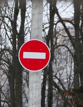 A road sign on a pole. Passage is forbidden, round white on red. High quality photo