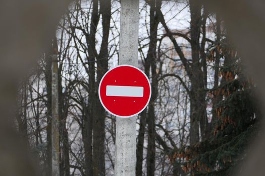 A road sign on a pole. Passage is forbidden, round white on red. High quality photo