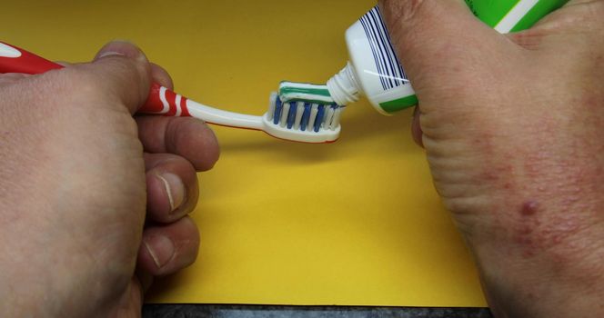 Toothpaste is applied to a toothbrush to brush your teeth