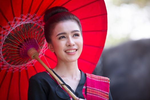 Portrait Of Young Woman Standing By Elephant In Forest