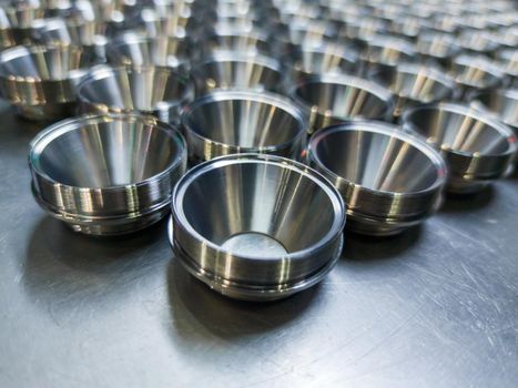 batch of shiny metal cnc aerospace parts production - close-up with selective focus for industrial background composition