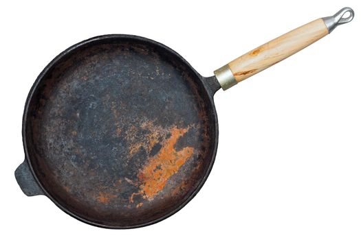 Rusted cast iron pan with wooden grip isolated on white background