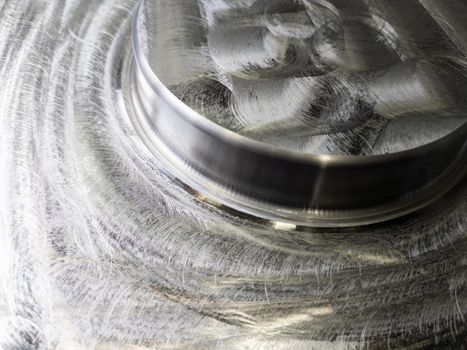 round steel workpiece after cnc surface milling - full frame industrial cnc technology backdrop.