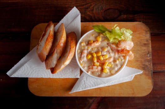 Bowl of homemade corn chowder soup with potatoes, carrots and shrimp.English shrimp chowder soup