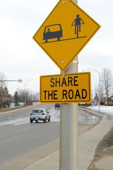 A Canadian roadsign informing traffic to share the lanes with cyclists as well as motor vehicles.