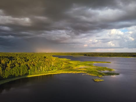 Stromy clouds over eautful peninsula between lakes Snudy and Strusto, National Park Braslau Lakes, Belarus.