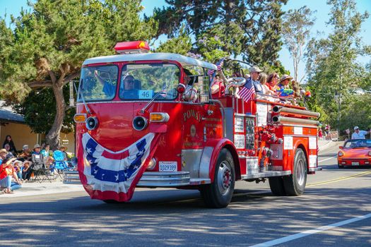 Old Firetruck and people at the July 4th Independence Day Parade in Rancho Bernardo, San Diego, California, USA. July 4th 2020