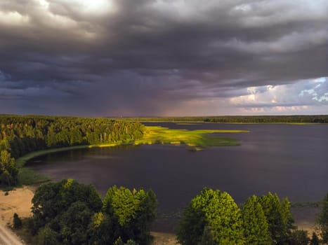 Stromy clouds over eautful peninsula between lakes Snudy and Strusto, National Park Braslau Lakes, Belarus.