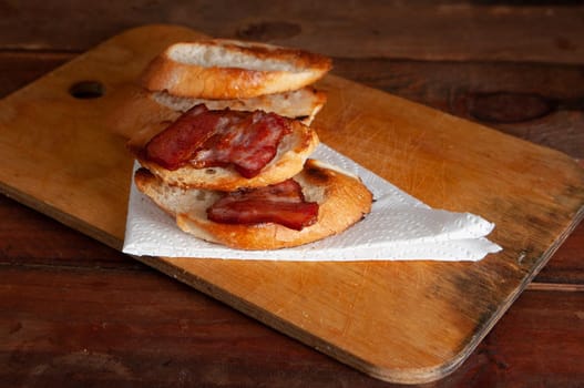 Using thick-sliced bacon to make a sandwich on whole-grain bread.