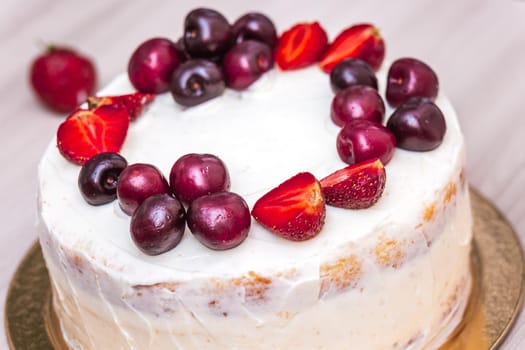 Cherries and strawberries on top of cheesecake with coconut.