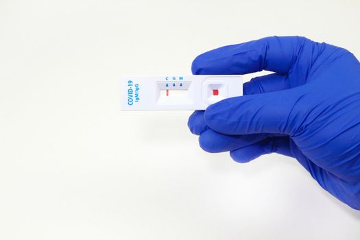 Medical worker holding negative rapid Diagnostic Test cassette identifying antibodies for Coronavirus SARS-CoV-2 COVID-19