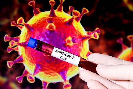 Hand holding test tube with blood sample for Covid-19 virus test and microscopic image of covid virus in the background. 