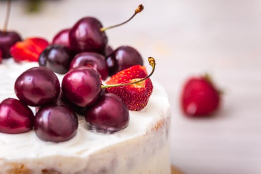 Cherries and strawberries on top of cheesecake with coconut.