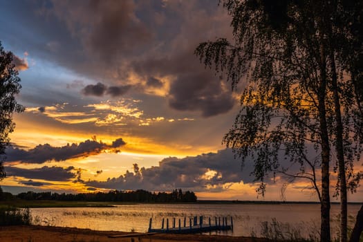 Amazing sunset at the Braslaw lakes with the cloudy sky. Braslaw district, Belarus.